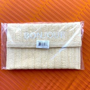Neiman Marcus straw clutch with BONJOUR embroidered